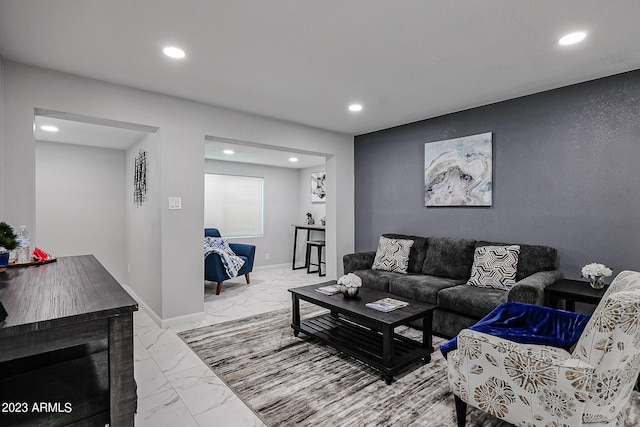 living area featuring recessed lighting, marble finish floor, and baseboards