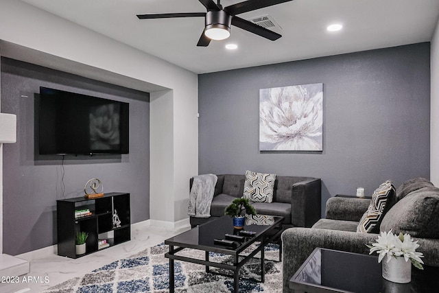living area featuring baseboards, a ceiling fan, marble finish floor, and recessed lighting