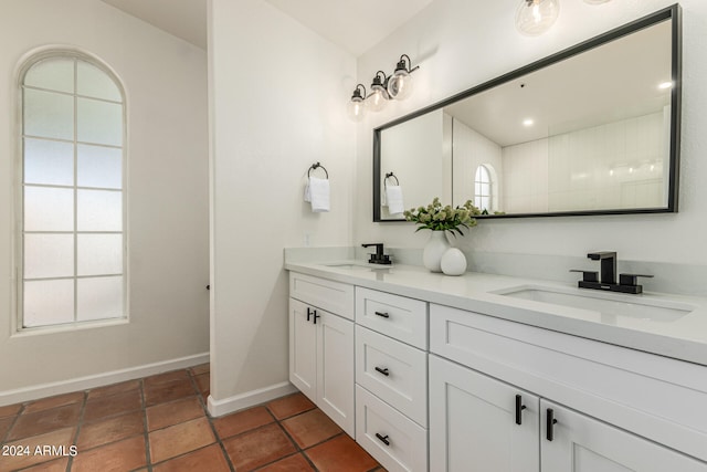 bathroom with tile patterned flooring and dual bowl vanity