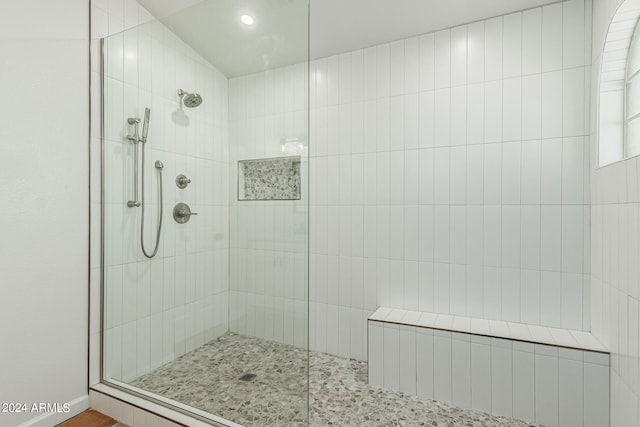 bathroom featuring a shower with shower door