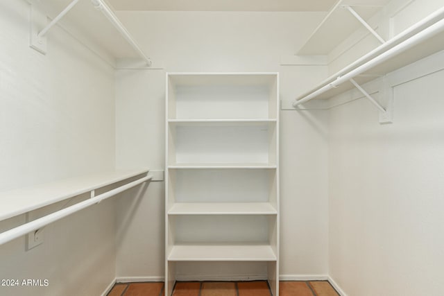 walk in closet with tile patterned floors