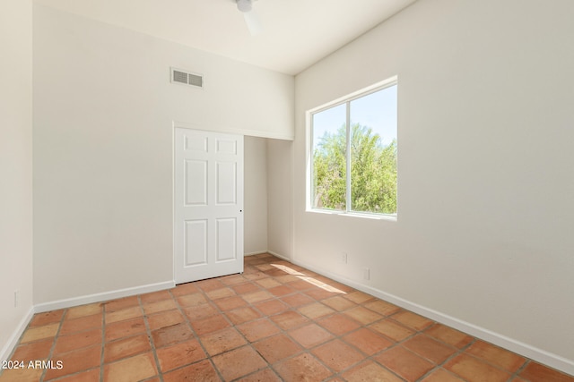 spare room featuring ceiling fan and tile patterned floors