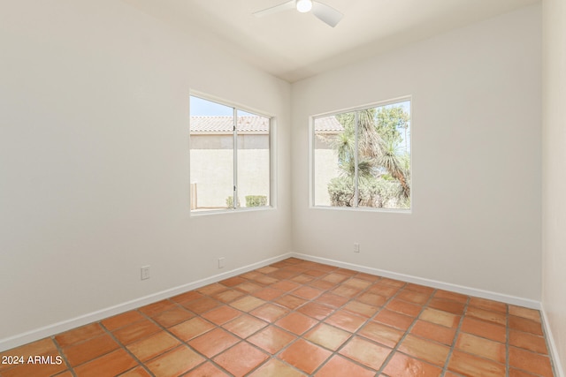 tiled spare room featuring ceiling fan