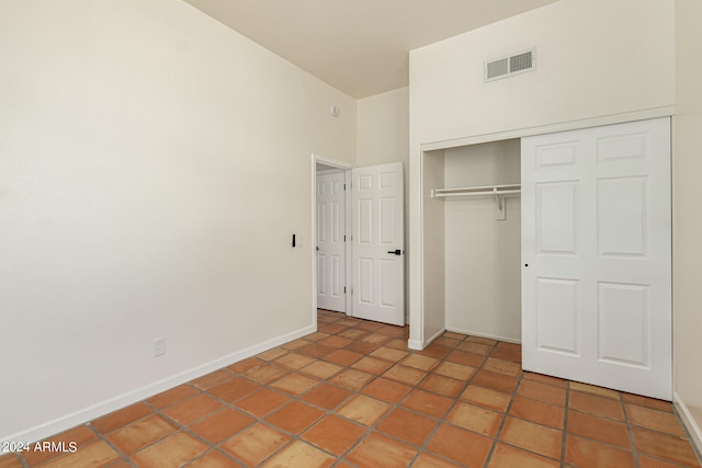 unfurnished bedroom featuring a closet and tile patterned floors