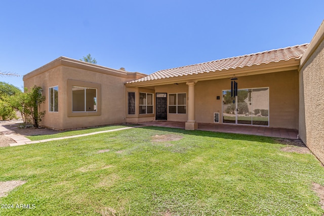 rear view of house with a yard