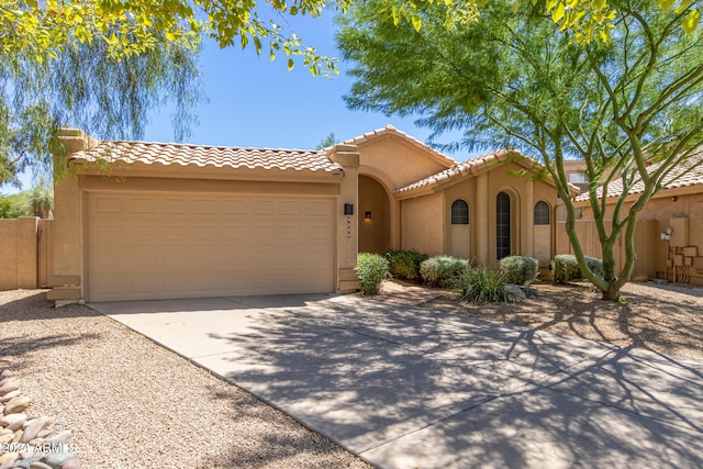 mediterranean / spanish-style home with a garage