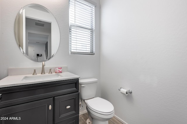 bathroom featuring hardwood / wood-style flooring, vanity, and toilet