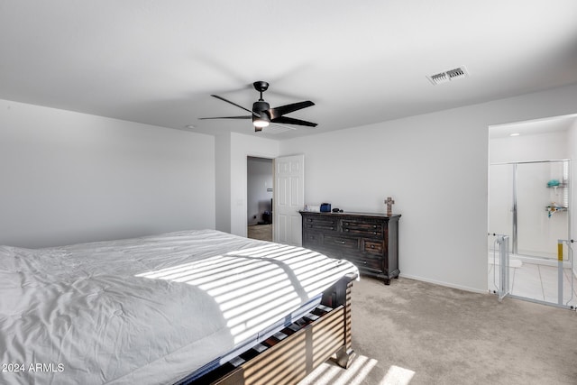 carpeted bedroom featuring ceiling fan and ensuite bathroom