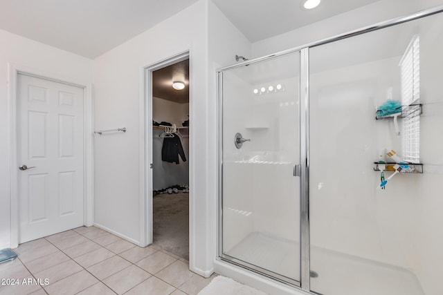 bathroom featuring tile patterned floors and a shower with door