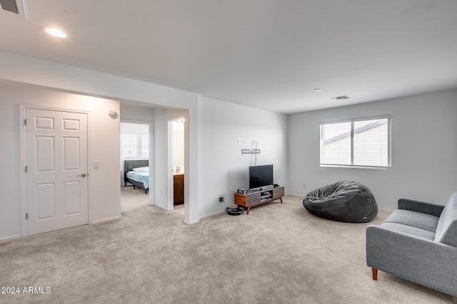 living room with a wealth of natural light and light carpet