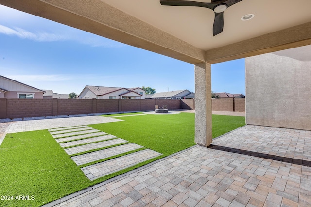 view of yard featuring a patio and ceiling fan