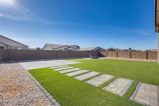 view of yard with a patio and an outdoor fire pit