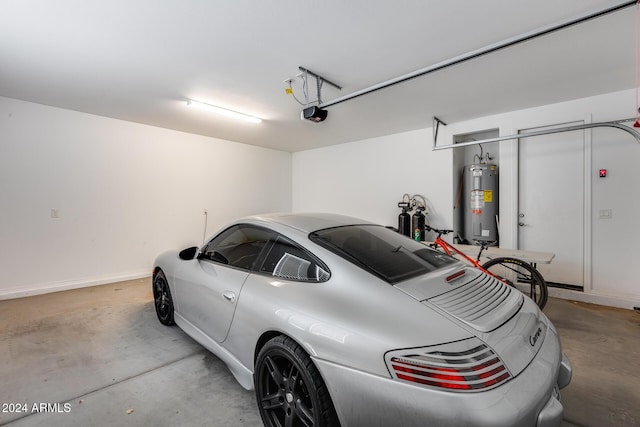 garage featuring a garage door opener and water heater