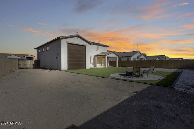 exterior space featuring a garage, an outdoor structure, and a patio area