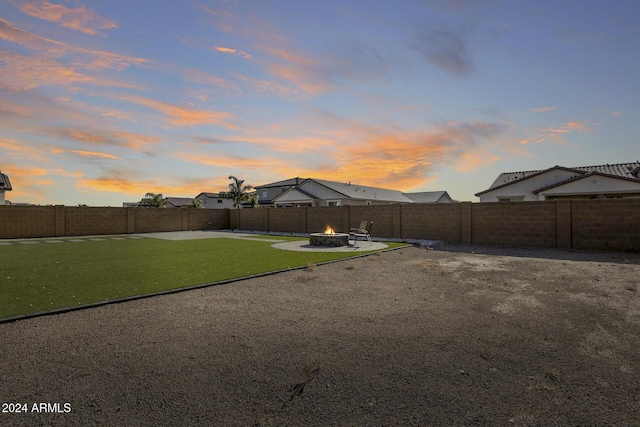 yard at dusk with a fire pit