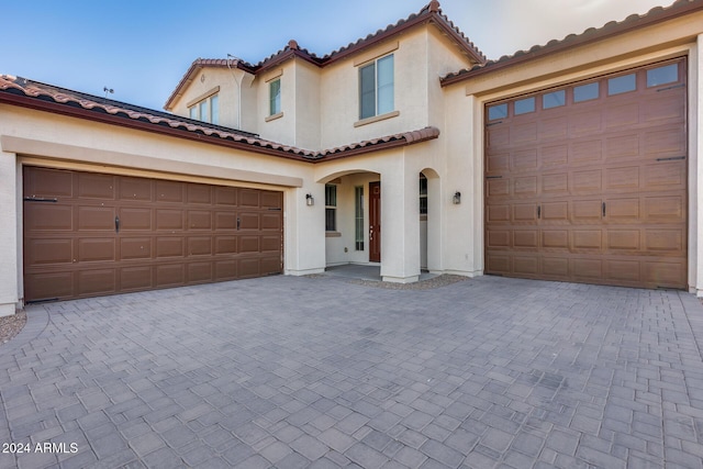 mediterranean / spanish-style home with a garage