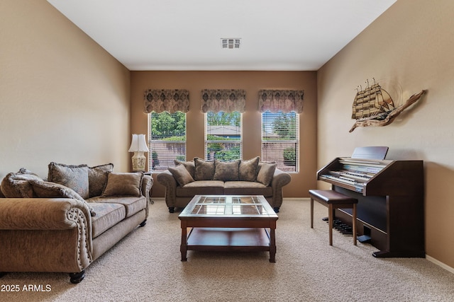 living room featuring visible vents, baseboards, and light carpet