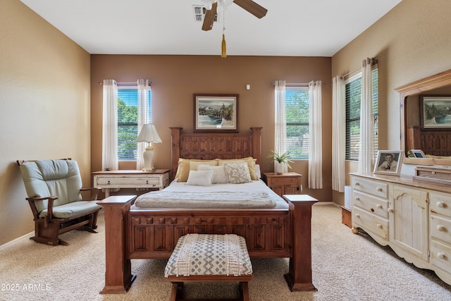 bedroom featuring multiple windows, light carpet, and ceiling fan