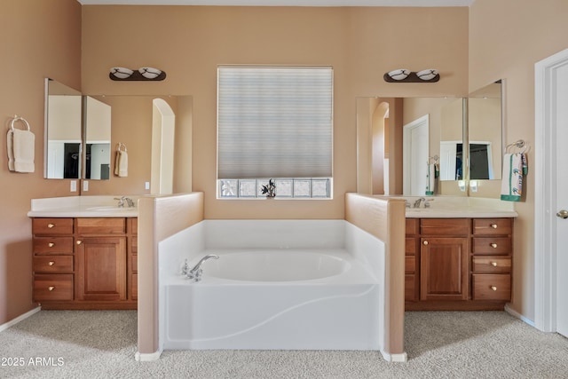 full bath featuring a sink, carpet flooring, a bath, and two vanities
