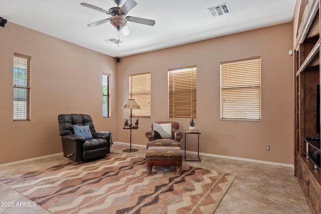 living area with baseboards, a ceiling fan, carpet floors, and visible vents