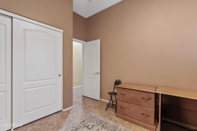 bedroom featuring baseboards and a closet
