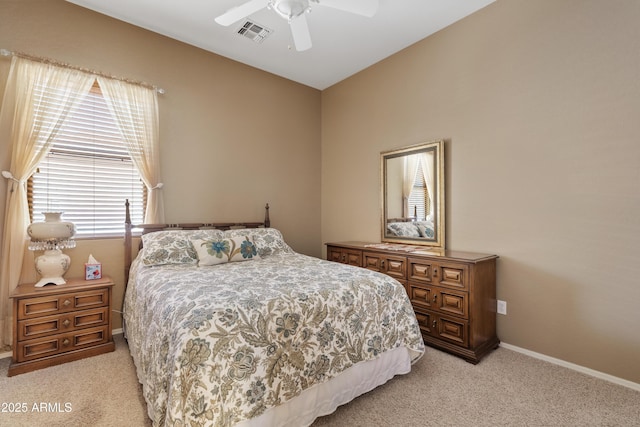 bedroom with visible vents, baseboards, ceiling fan, and light carpet