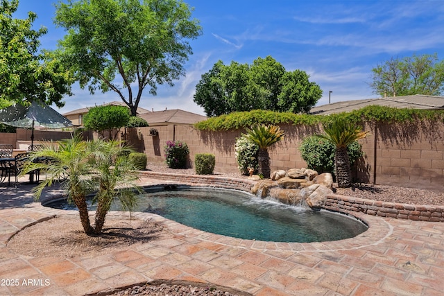view of pool with a fenced backyard and a patio area