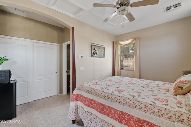 bedroom with ceiling fan, light carpet, a closet, and visible vents