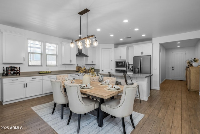 dining area with visible vents, recessed lighting, baseboards, and wood finished floors