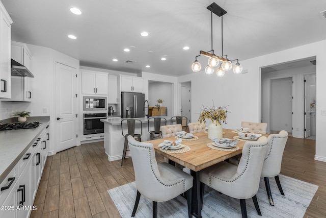 dining room with recessed lighting, visible vents, and wood finished floors