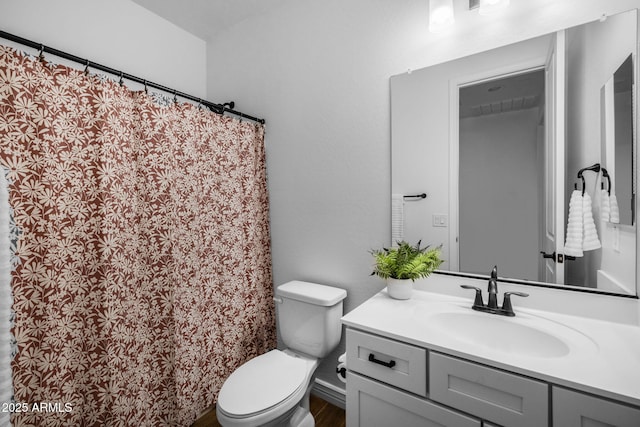 bathroom featuring toilet and vanity