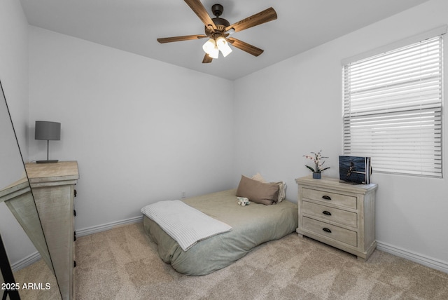 carpeted bedroom featuring baseboards and ceiling fan