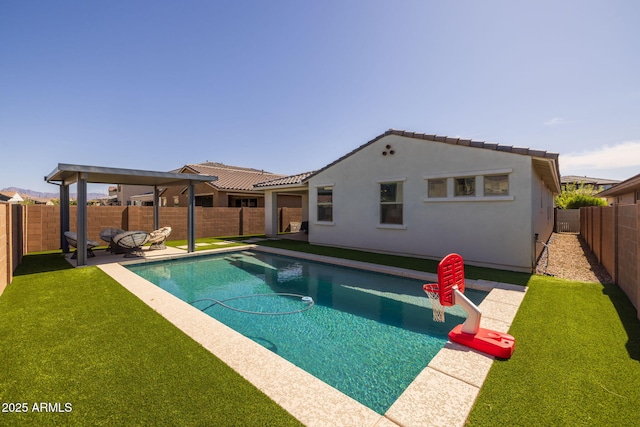 view of swimming pool featuring a fenced backyard, a lawn, a patio, and a fenced in pool