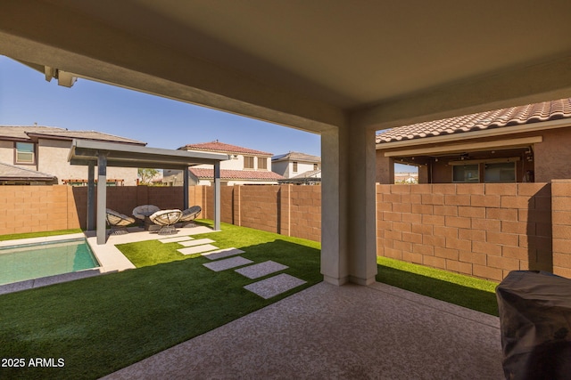 view of yard featuring a fenced in pool, a fenced backyard, and a patio area