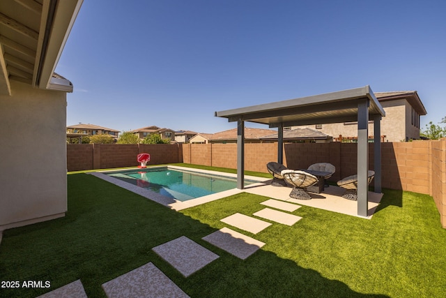 view of pool featuring a yard, a fenced in pool, a fenced backyard, and a patio area