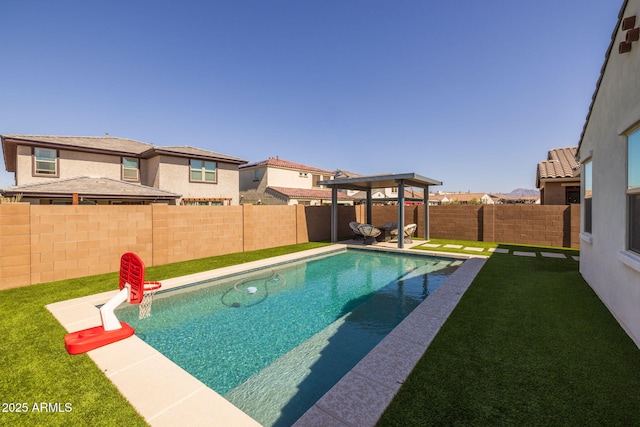 view of pool featuring a fenced in pool, a lawn, and a fenced backyard