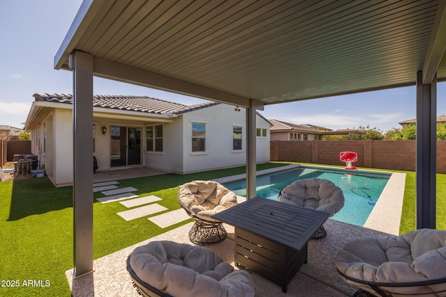 view of pool with a fenced in pool, a patio, a lawn, and a fenced backyard