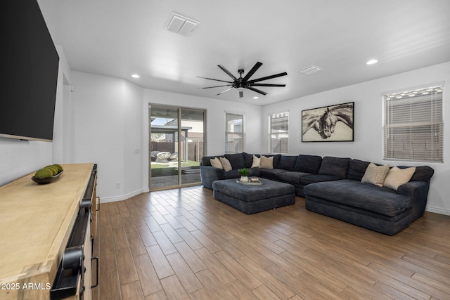 living room featuring recessed lighting, visible vents, and wood finished floors