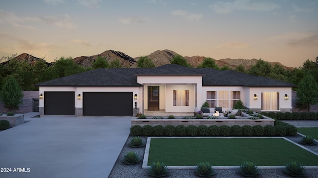 view of front of property with a mountain view and a garage