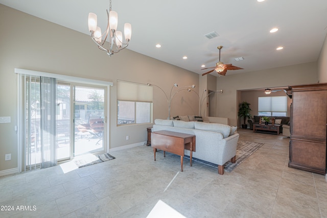 living room featuring ceiling fan with notable chandelier and light tile patterned flooring