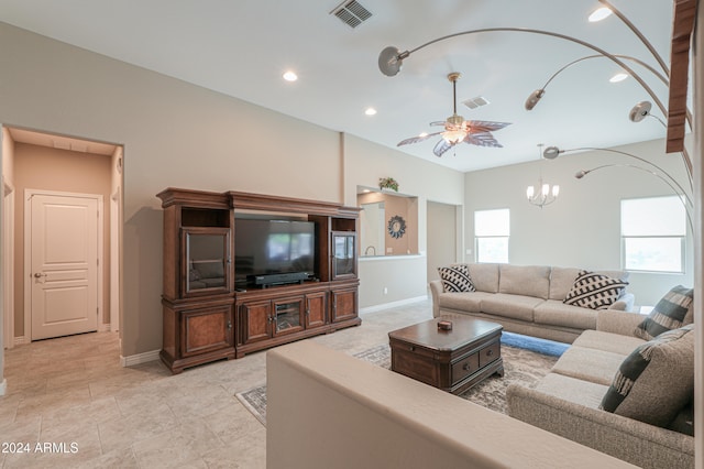 living room featuring ceiling fan with notable chandelier