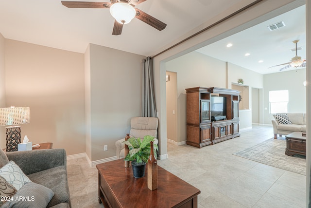 tiled living room featuring ceiling fan