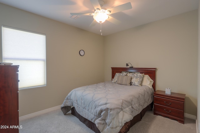 bedroom with ceiling fan and light colored carpet