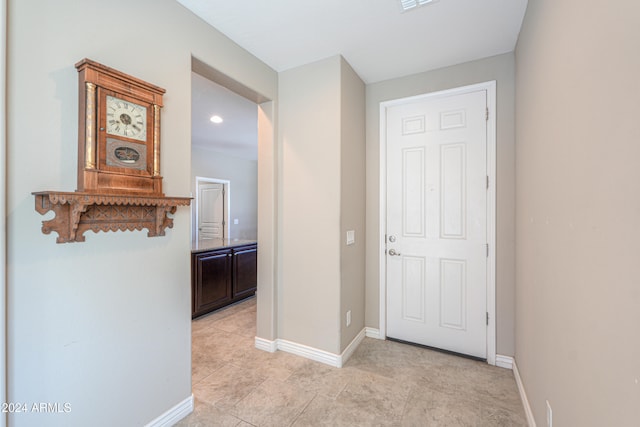 hall featuring light tile patterned floors