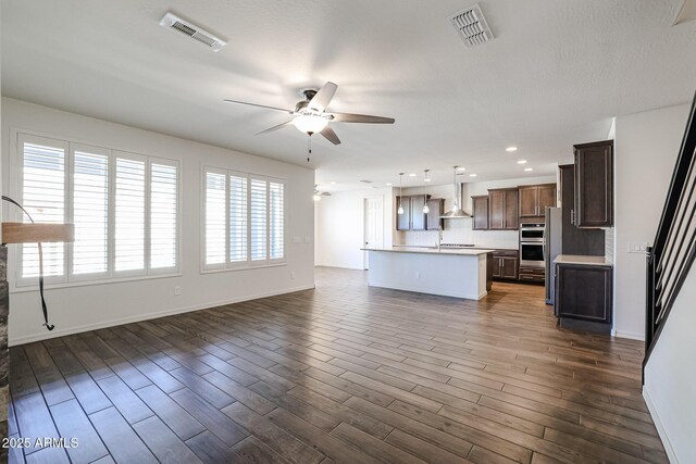 living room with ceiling fan and hardwood / wood-style flooring