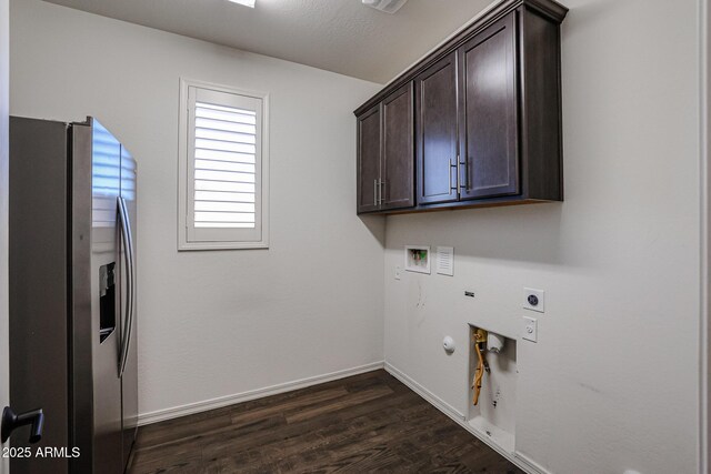 kitchen with hanging light fixtures, dark wood-type flooring, a stone fireplace, ceiling fan, and a kitchen island with sink