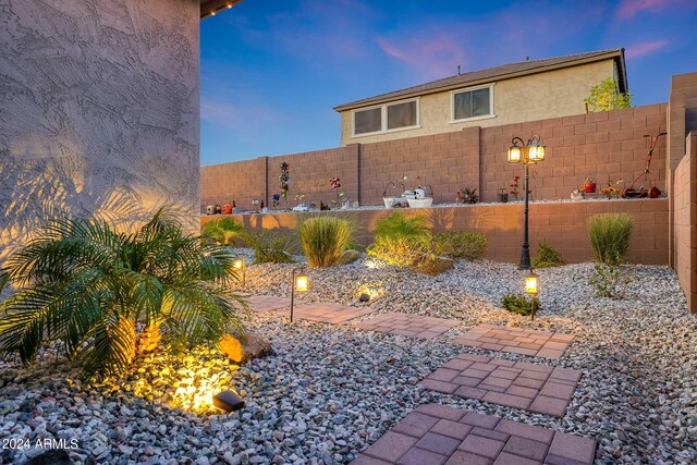 yard at dusk featuring a mountain view, a patio area, and a gazebo