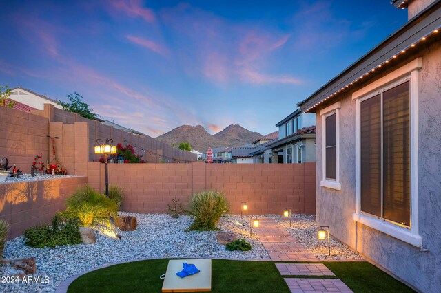 back house at dusk with a gazebo and a patio area