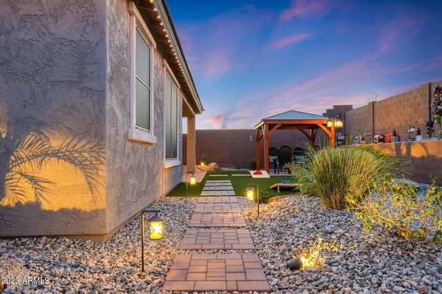 yard at dusk featuring a mountain view