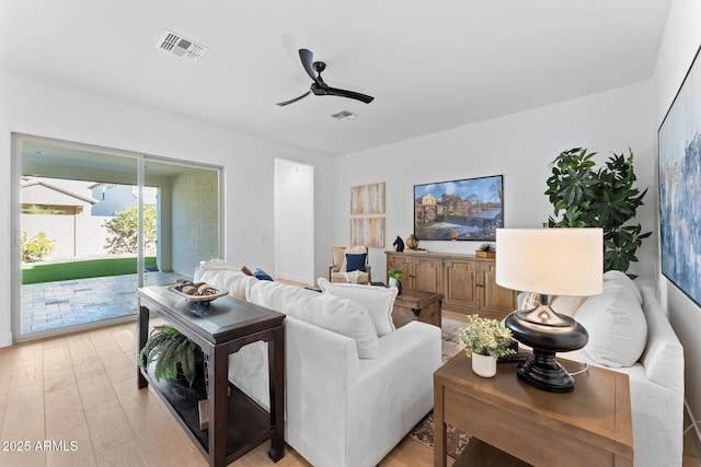 living room with ceiling fan and light wood-type flooring